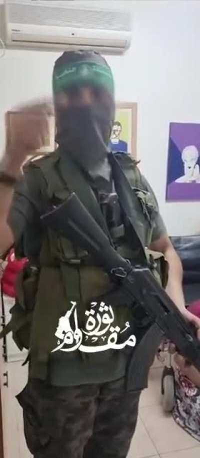 Hamas terrorist whitewashing his capture of an elderly woman and her caretaker, claiming he is there to 