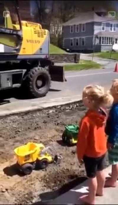 Bagger machine operator takes a minute to bring some smiles for kids