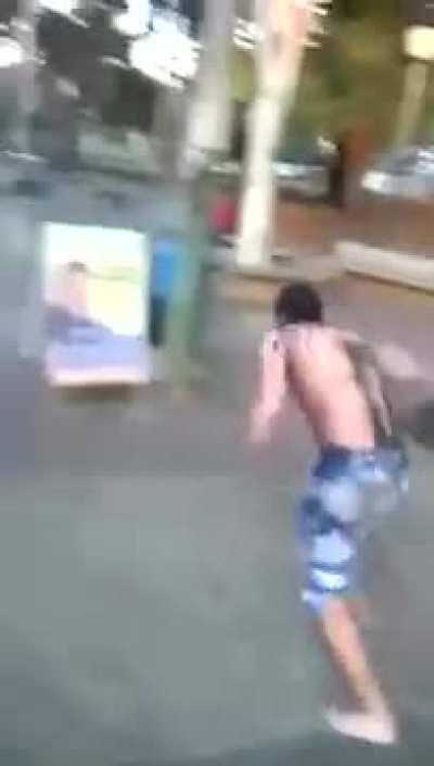 Drunk and shirtless fighting a sign