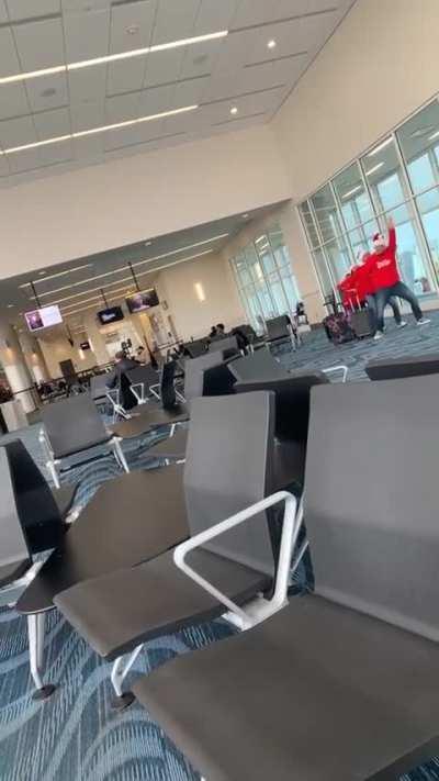 Behind the scenes of a family of vloggers making a TikTok in an airport terminal