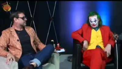 The TV presenter gets scared when the joker offers alcohol gel