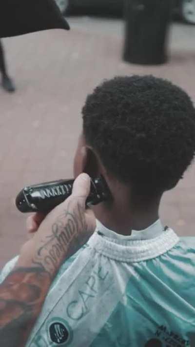 street barber gives free haircut to kid in Atlanta and gives them some solid mentoring along the way