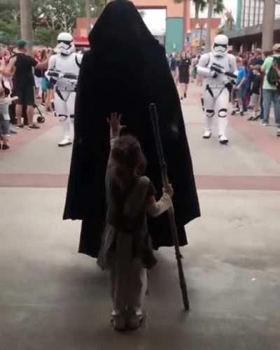 Four-year-old girl dressed as Rey meets Star Wars characters.