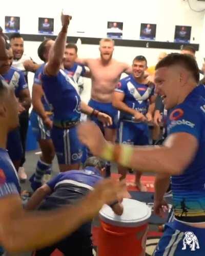Adam Elliott leads the team victory song in the sheds