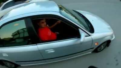 Two guys get sprayed like flys while trying to beat the motorcycle dude