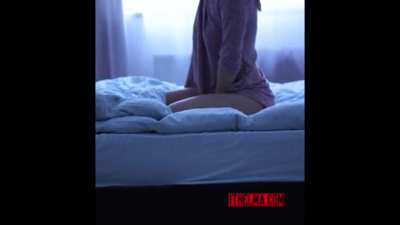 Standing outside the bedroom door.