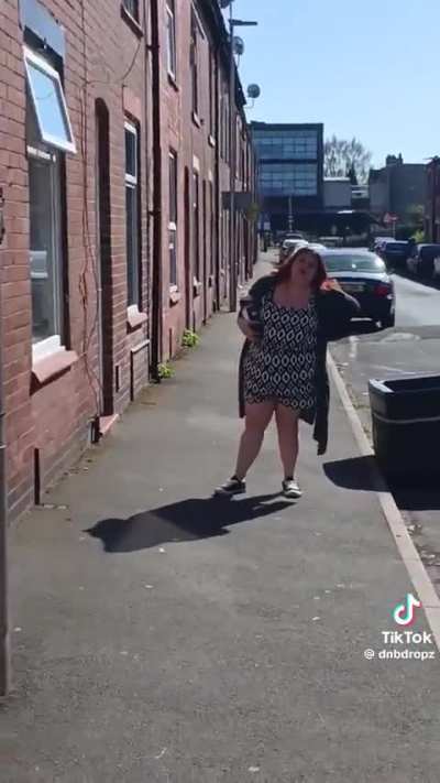 A woman threatens a man in a council estate in Leigh, UK
