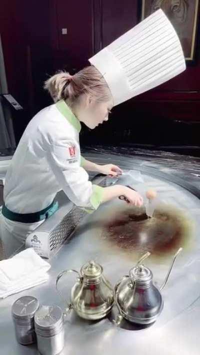 cook handles egg with a lot of skill