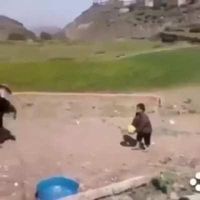Child playing with goat