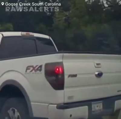 18-wheeler carrying a military tank getting stuck on railroad tracks and being struck by a CSX freight train