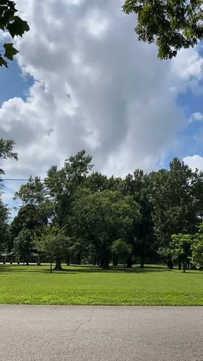 Rolling Clouds Over Park Path