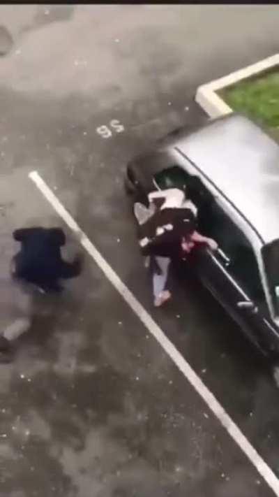 Angry woman attacks car, gets taken out by a dude