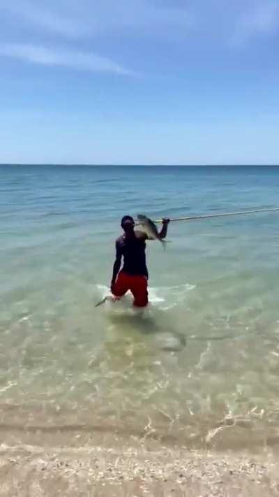 Australian Aboriginal spear fishing from the shore.