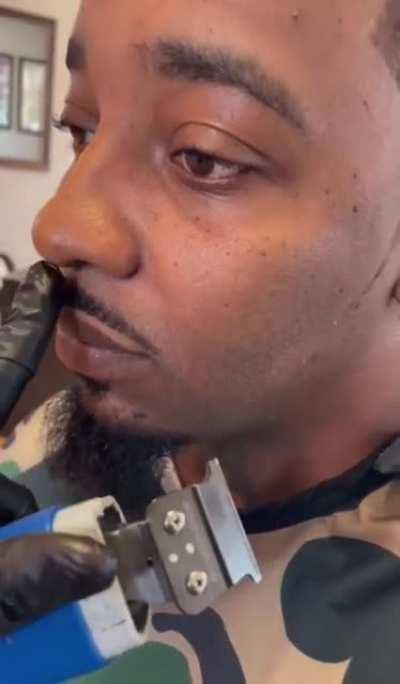 Barber trimming a mustache
