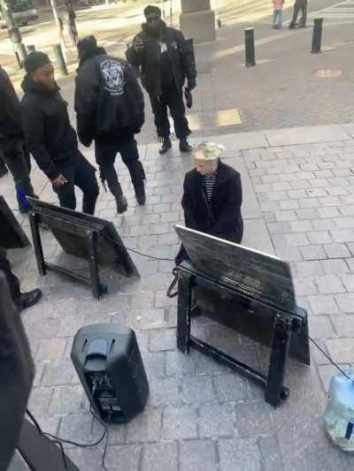 White woman kissing boots of Black Hebrew Israelites a separatist hate group known of their antisemitic and anti-white beliefs