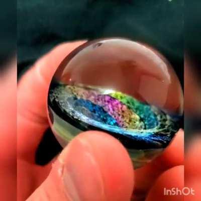 This beautiful hand made spiral galaxy marble.