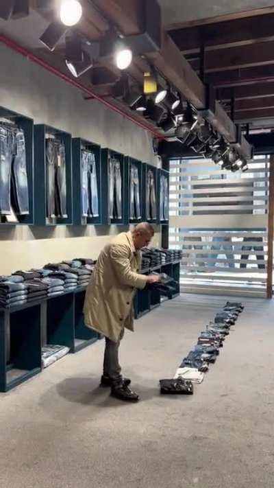 Guy does fast flip jeans folding