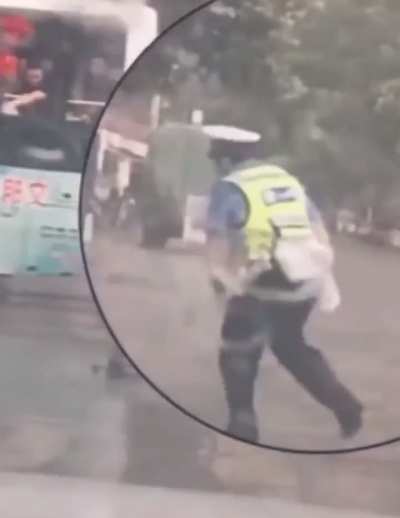 A passenger saw the officer standing in the rain and tossed him an umbrella.