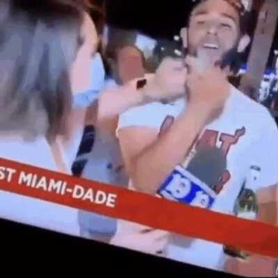 Reporter reminds Miami Heat fan celebrating their conference championship win to wear his mask