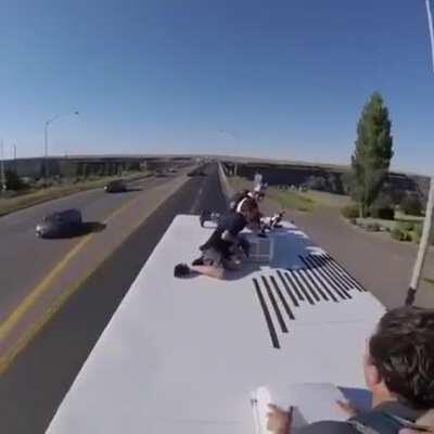Parachuting off a truck driving over bridge