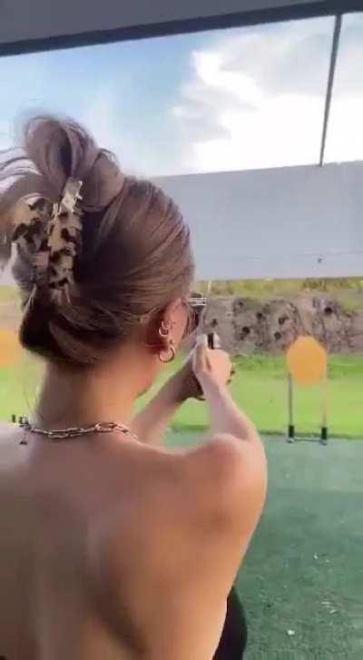 WCGW touching the barrel of a gun at a shooting range