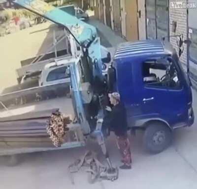 Idiot tries to stop truck from falling and nearly dies