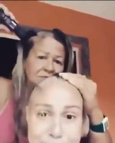 Mom shaves her head to show support for her daughter undergoing chemo. Mothers are the best!