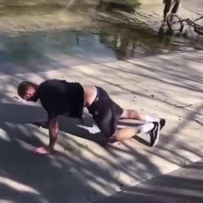 Jumping over a bridge on a bike and skidding across the concrete