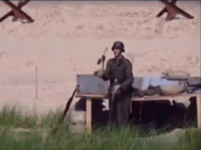 German soldier juggling grenades at Omaha Beach in WWII