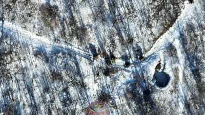 Russian Soldiers Stop Long Enough to Allow for a Ukrainian Drone to Land a Perfect Hit with What Appears to be a Mortar Round