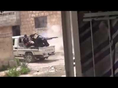 FSA Rebel firing an AA gun mounted on a Technical hits ally, Aleppo - Syria - 2013