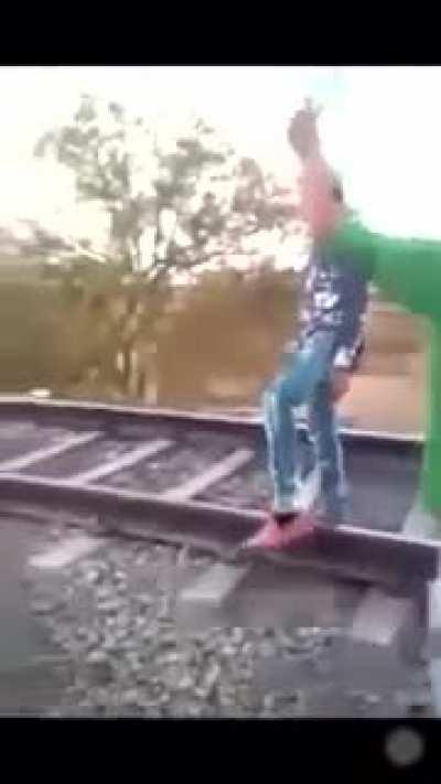 Standing near the railway.