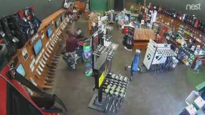 Man accidentally drops all the golf bags from the shelf...........