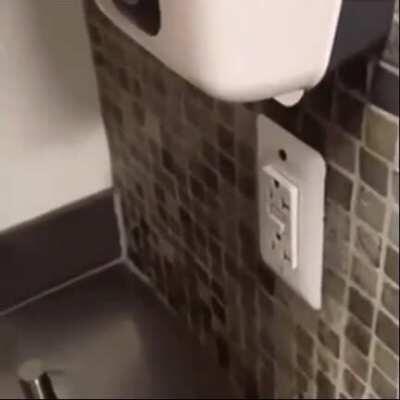 an electrical plug directly under a soap dispenser
