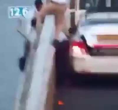 A taxi driver grabbed a woman by the hair at the last moment as she tried to commit suicide on a bridge.