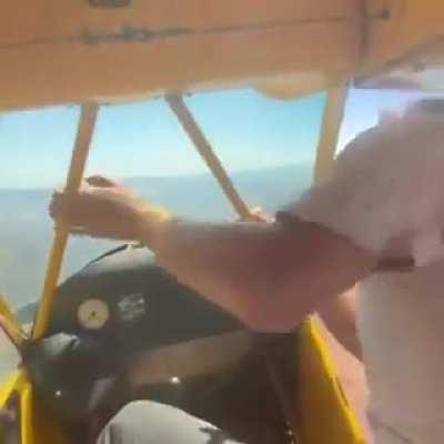hand starting a plane mid air