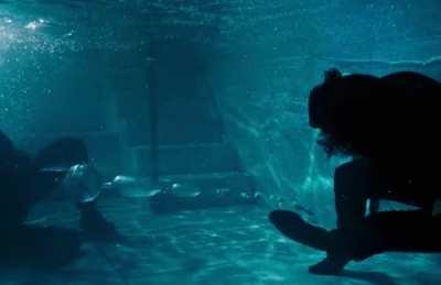 In John Wick: Chapter 3 – Parabellum (2019), John Wick and an enemy fall into a pool and Wick immediately moves roughly three feet away just before being fired upon. At this distance the bullets are rendered ineffective which is consistent with how a typi