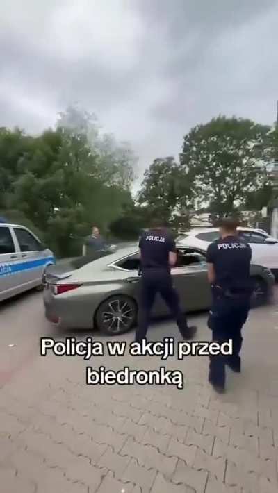 Polish Police try to stop a crazy driver outside a popular supermarket.