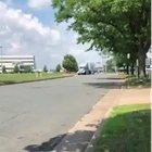 Semi truck with traffic light stuck on trailer.