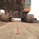 Skilled excavator driver attempting the lighter trick
