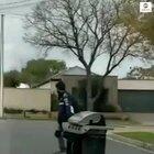 Meals on Wheels?!! Skateboarder cruises through neighborhood while towing a barbecue.