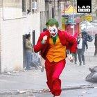 Joaquin Phoenix as The Joker running all over Gotham