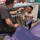 Dentist helps his nervous patient get comfortable before his checkup