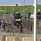 To ride a motorbike next to the harbour