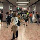 Hong Kong police surge from the stairs of a railway station and assault fleeing protesters