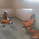 Indian sadhu’s (holy men) enjoying chillum(clay pipe) while maintaining social distancing in these tough times