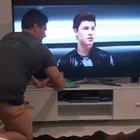 Just a man cleaning the TV screen