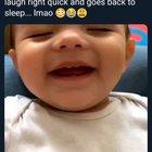 Wakes up to laugh and then goes back to sleep