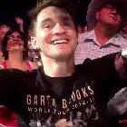 Garth Brooks giving his guitar to a fan