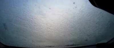 Water on the front windscreen of the car turns into ice immediately, blocking the driver's view.